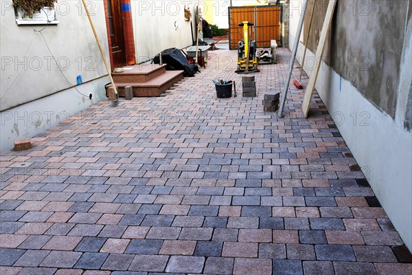 Worker lays paving stones