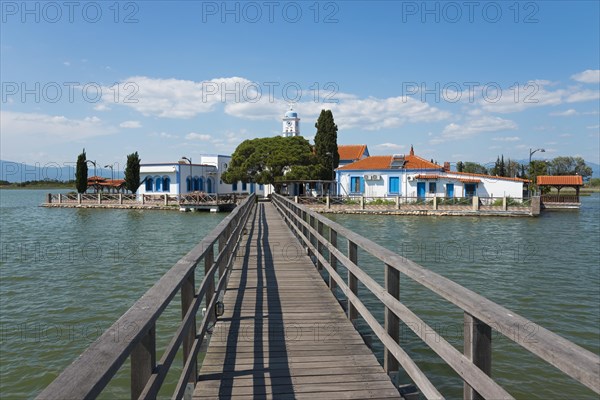 Monastery complex with church at the end of a bridge over calm water, Monastery of St Nicholas, Monastery of Agios Nikolaos, Agiou Nikolaou, Vistonidas Burma Lagoon, Porto Lagos, Xanthi, Eastern Macedonia and Thrace, Greece, Europe