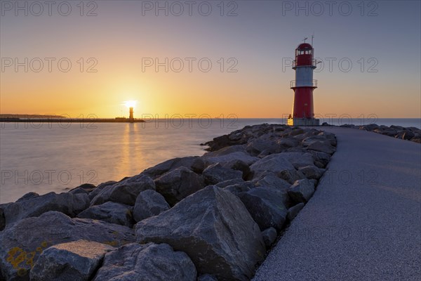 The two lighthouses of Warnemuende near Rostock on the Baltic Sea at sunset as a long exposure