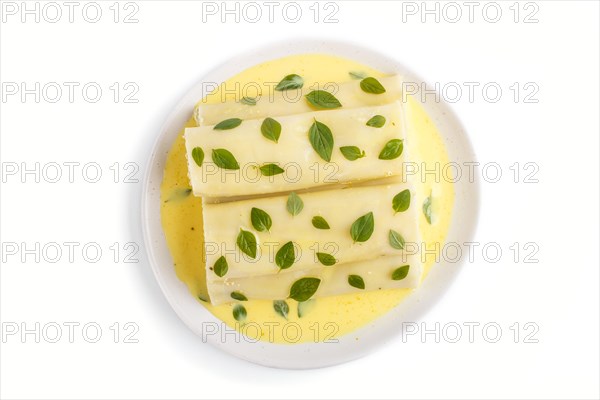 Cannelloni pasta with egg sauce, cream cheese and oregano leaves isolated on white background. top view, flat lay, close up