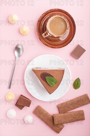 Cake with souffle milk chocolate cream with cup of coffee, meringues on a pink pastel background. top view, flat lay, close up. breakfast concept