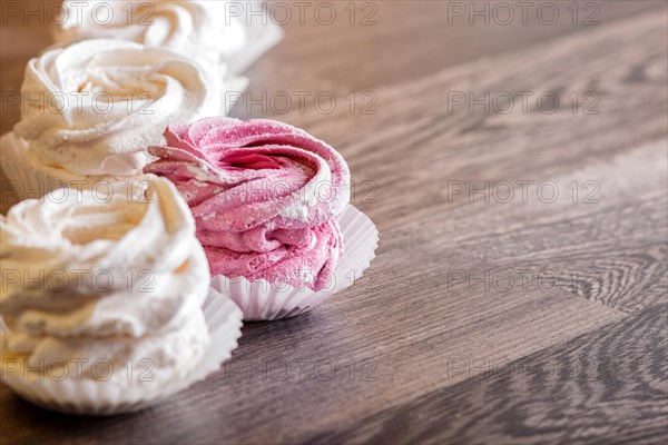 Pink and white homemade marshmallows on a gray wooden background. selective focus