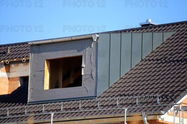 Roofer working on a new dormer window