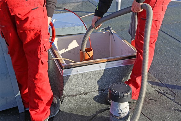 Workers from Abfluss AS clean the exhaust air ducts in an apartment block in Mannheim