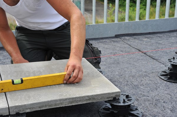 Worker lays paving stones