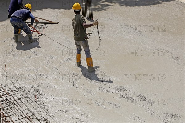 Concreting a floor slab with ready-mixed concrete on the construction site of a residential building