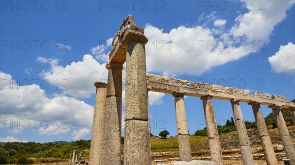 Ancient portico under a blue sky with white clouds, Archaeological site, Ancient Messene, capital of Messinia, Messini, Peloponnese, Greece, Europe