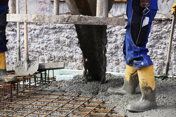 Concreting a floor slab with ready-mixed concrete on the construction site of a residential building