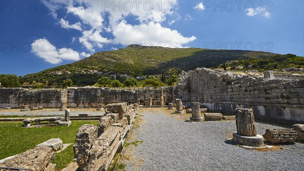 Ruins of an ancient site with broken columns and stones under a blue sky, Sanctuary of Asclepius, Ekklesiasterion, Meeting place of the citizens, Archaeological site, Ancient Messene, Capital of Messinia, Messini, Peloponnese, Greece, Europe