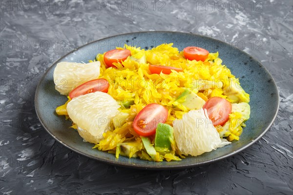 Fried pomelo with tomatoes and avocado on black concrete background. side view, myanmar food