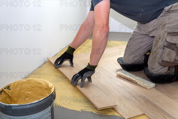 Craftsmen laying herringbone parquet professionally