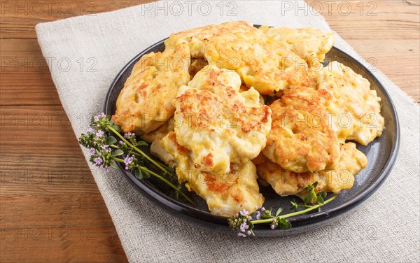 Minced chicken cutlets on brown wooden background. side view, close up