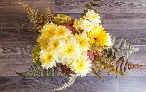 Bouquet of gerbera and chrysanthemum on a wooden background. floristic composition