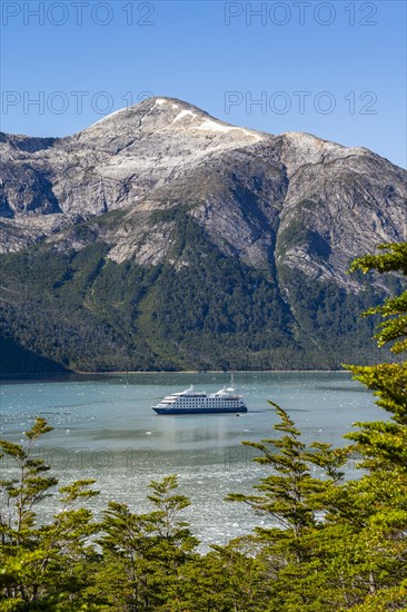 Cruise ship Stella Australis anchored between ice floes in Pia Bay in front of the Pia Glacier, Alberto de Agostini National Park, Avenue of the Glaciers, Chilean Arctic, Patagonia, Chile, South America