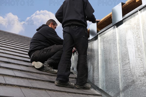 Roofer working on a new dormer window (model relased)