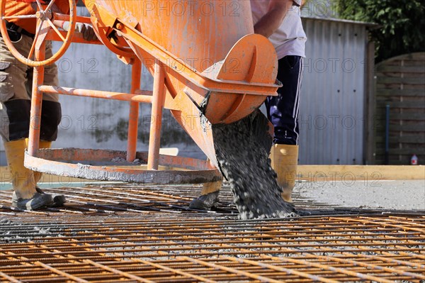 Concreting a floor slab with ready-mixed concrete on the construction site of a residential building