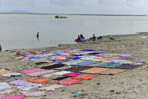 Washing clothes in the Irrawaddy, Myanmar, Asia