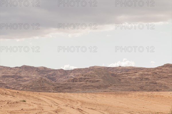 Desert, red mountains, rocks and cloudy sky. Egypt, color canyon, the Sinai Peninsula, Dahab