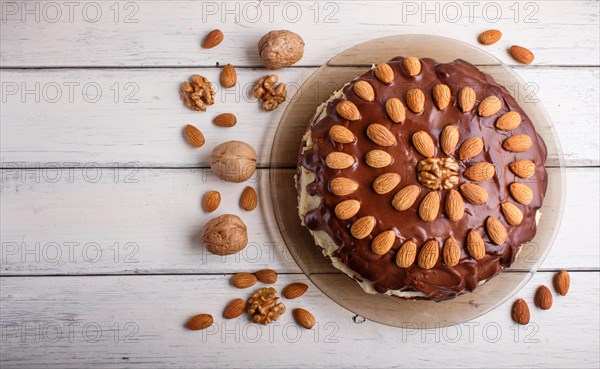 Homemade chocolate cake with almonds on white wooden background. top view, flat lay, copy space