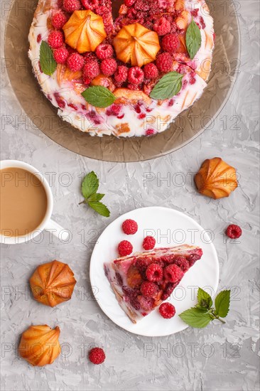 Homemade jelly cake with milk, cookies and raspberry on a gray concrete background with cup of coffee. top view. flat lay, copy space