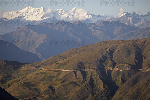 Road through the Andean highlands, snow-capped Andes in the background, Andahuaylas, Apurimac. region, Peru, South America