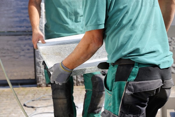 Worker lays paving stones