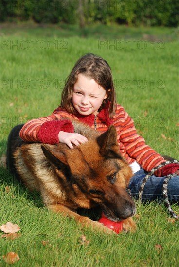 Portrait of a young girl petting her dog