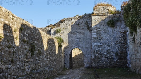 Shadow cast in a ruined fortress with stone archway, sea fortress Methoni, Peloponnese, Greece, Europe
