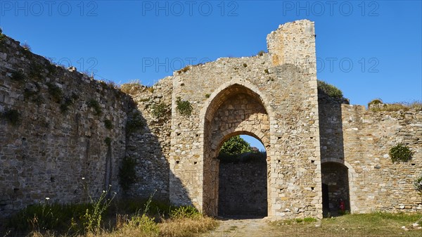 Ancient stone gate of a ruin with blue sky in the background, sea fortress Methoni, Peloponnese, Greece, Europe