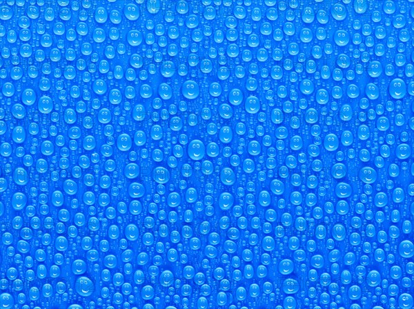 Many water drops on a blue surface, a smiley face is reflected in every drop