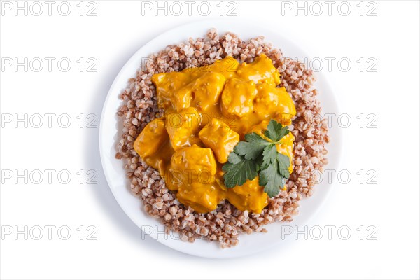 Buckwheat with chicken curry sauce isolated on white background. top view