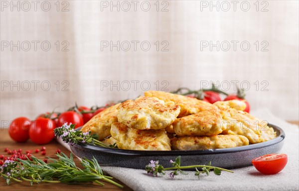 Minced chicken cutlets with herbs on brown wooden background. side view, copy space, selective focus