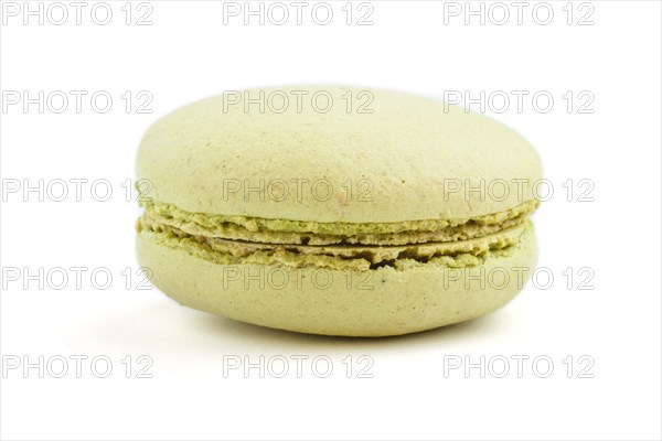 Single green macaron or macaroon cake isolated on white background. side view, close up, macro