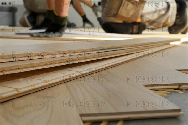 Craftsmen laying herringbone parquet professionally