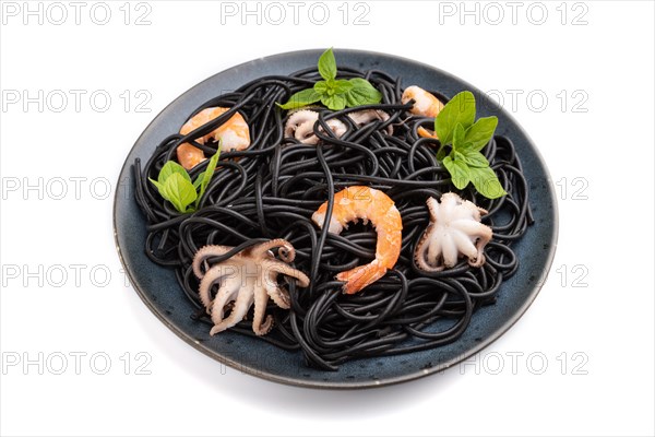 Black cuttlefish ink pasta with shrimps or prawns and small octopuses isolated on white background. Side view, close up