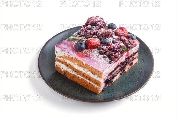 Berry cake with milk cream and blueberry jam on blue ceramic plate isolated on white background. side view, close up