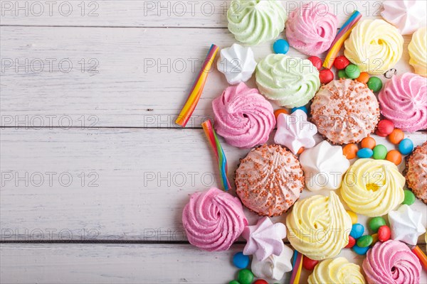 Mixed multicolored candies on white wooden background. copy space, top view, flat lay