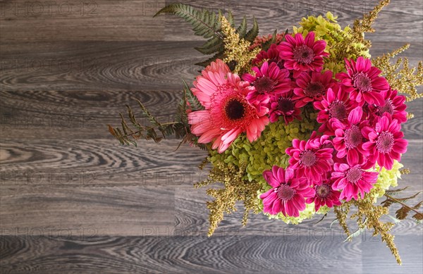 Bouquet of gerbera and chrysanthemum on a wooden background. floristic composition. copy space