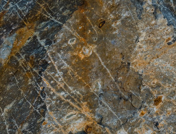 Closeup of granite boulder surface with visible marks created when quarried from ground in South Korea