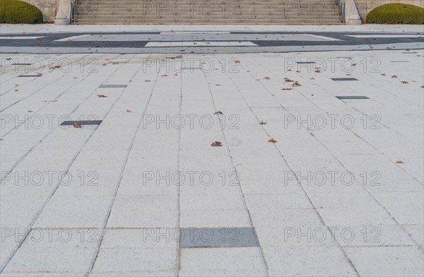 Closeup of concrete tile plaza with staircase in background in South Korea