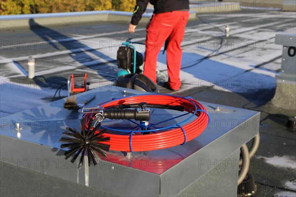 Workers from Abfluss AS clean the exhaust air ducts in an apartment block in Mannheim