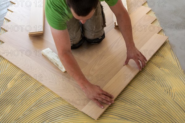 Craftsmen laying herringbone parquet professionally