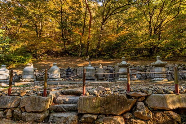 Collection of Buddhist stone carved urns on display at woodland park in South Korea