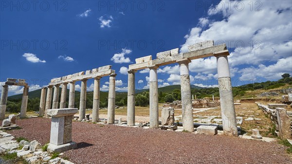Row of ancient columns under a bright blue sky on an archaeological site, Stoa of the Agora, Archaeological site, Ancient Messene, capital of Messinia, Messini, Peloponnese, Greece, Europe