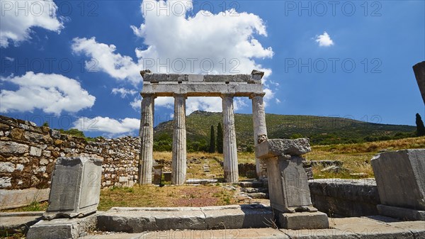 Ancient portico gate in the sunlight under a light blue sky with clouds, Gymnasion, Archaeological site, Ancient Messene, Capital of Messinia, Messini, Peloponnese, Greece, Europe