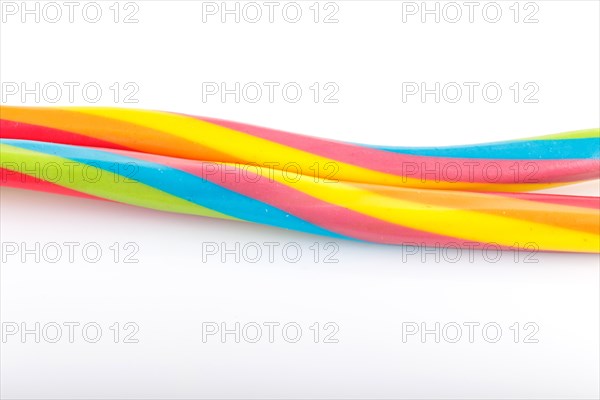 Long rainbow chewing caramel sugar candies isolated on white background. top view