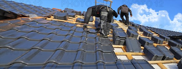 Panoramic image of the roof covering of a new tiled roof on a residential building