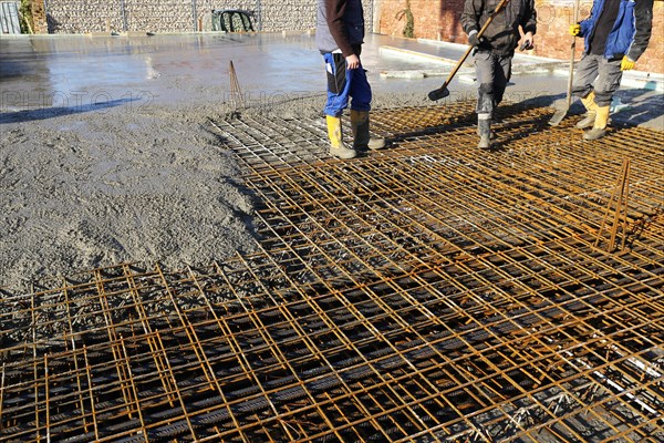 Concreting a floor slab with ready-mixed concrete on the construction site of a residential building