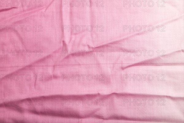 Fragment of smooth cotton purple tissue. Top view, flat lay, natural textile background and texture