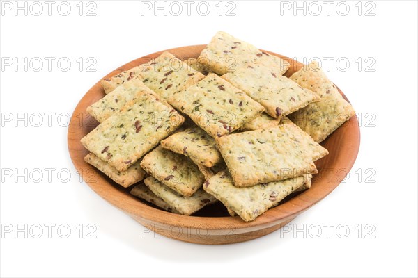 Small bread chips cookies with seeds in a wooden bowl isolated on white background. side view, close up